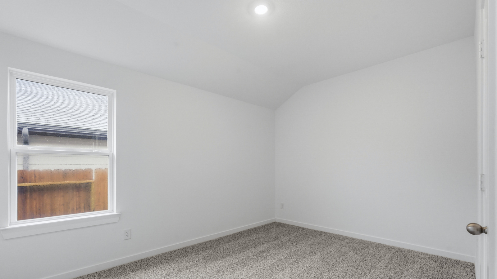 Secondary bedroom with carpet flooring