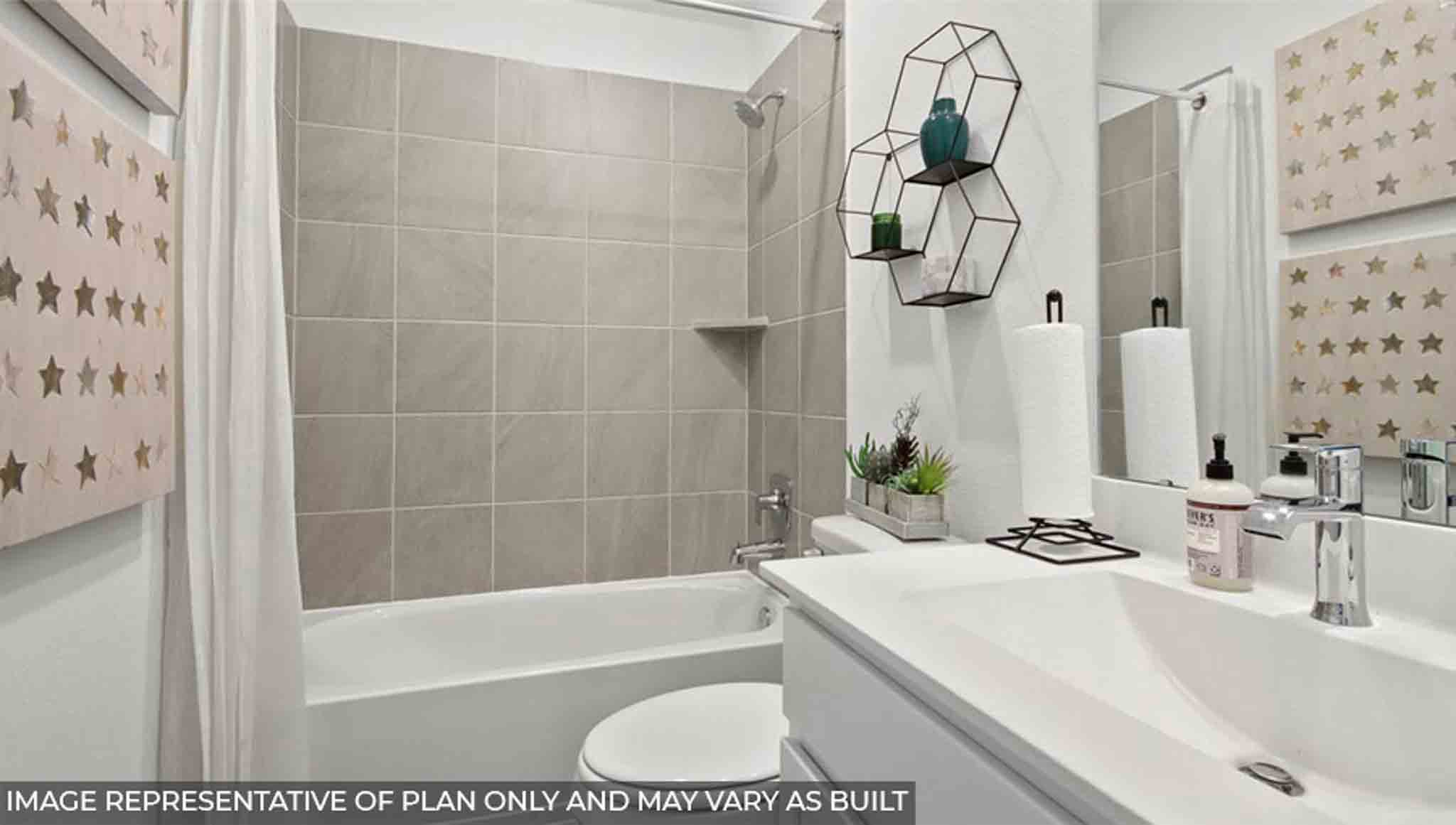 Secondary bathroom with vinyl flooring and a tile tub/shower combo.