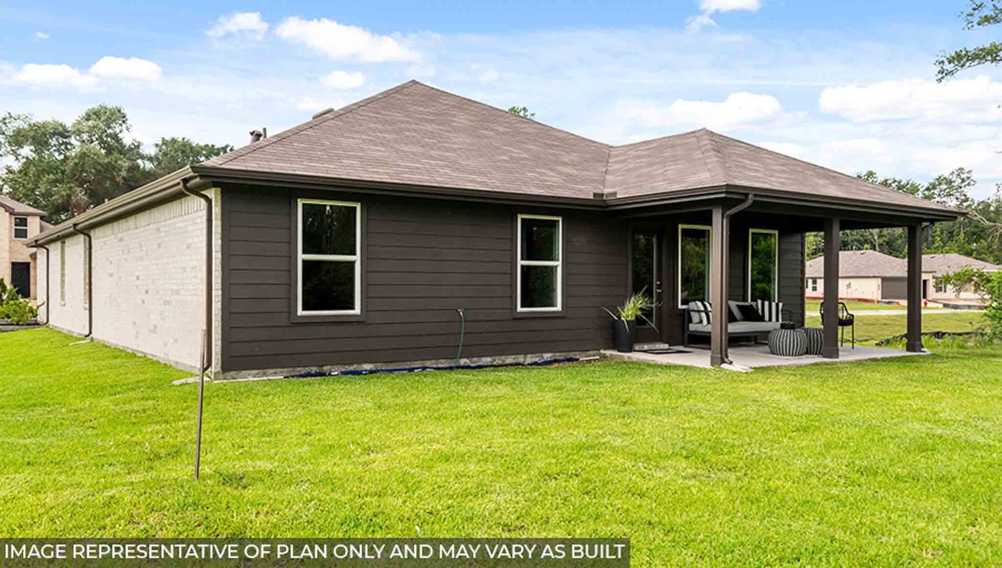 Spacious backyard with a back patio and overhead light.