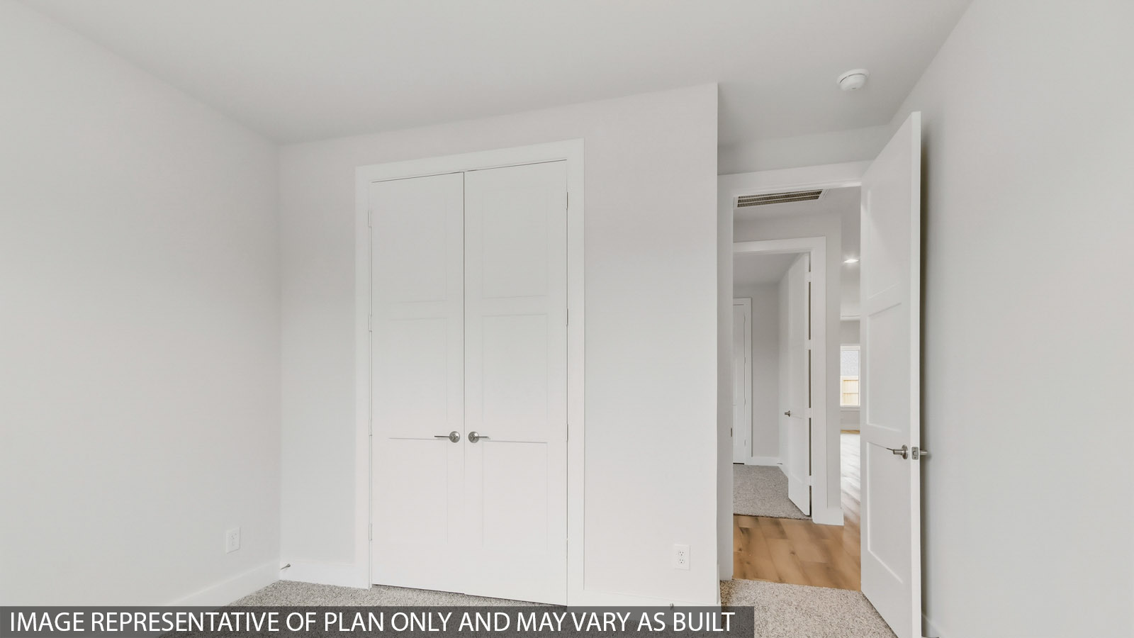 Secondary bedroom with carpet flooring