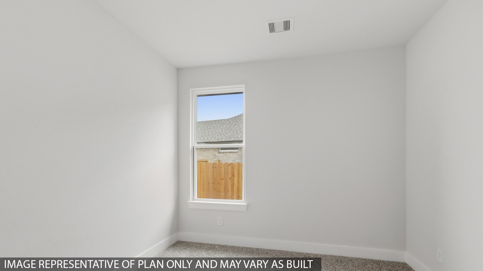 Secondary bedroom with carpet flooring