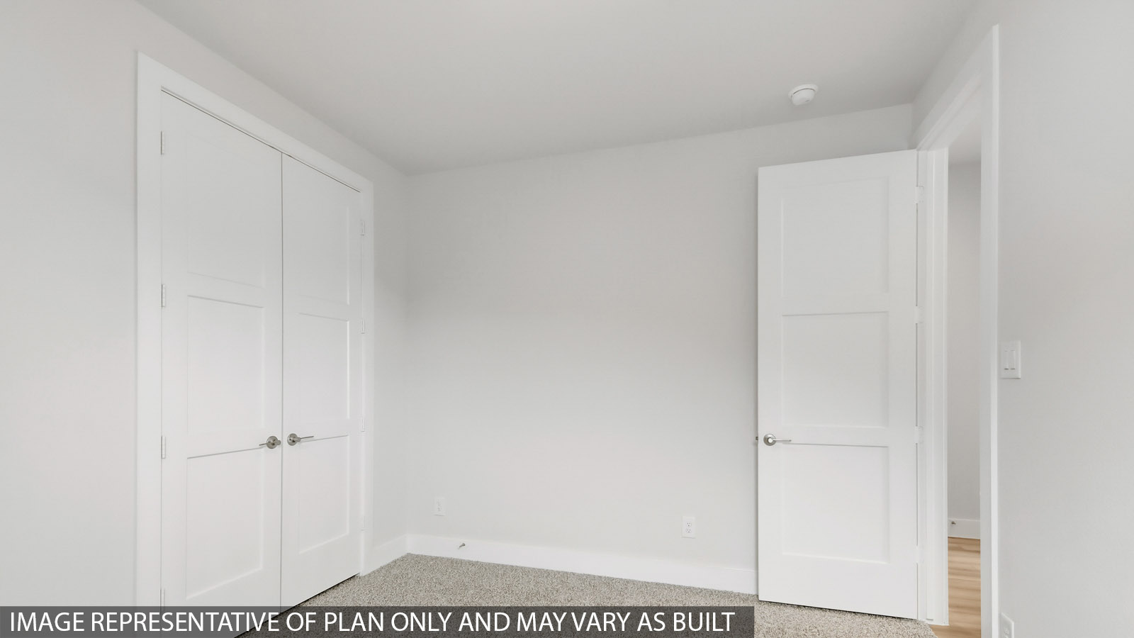 Secondary bedroom with carpet flooring