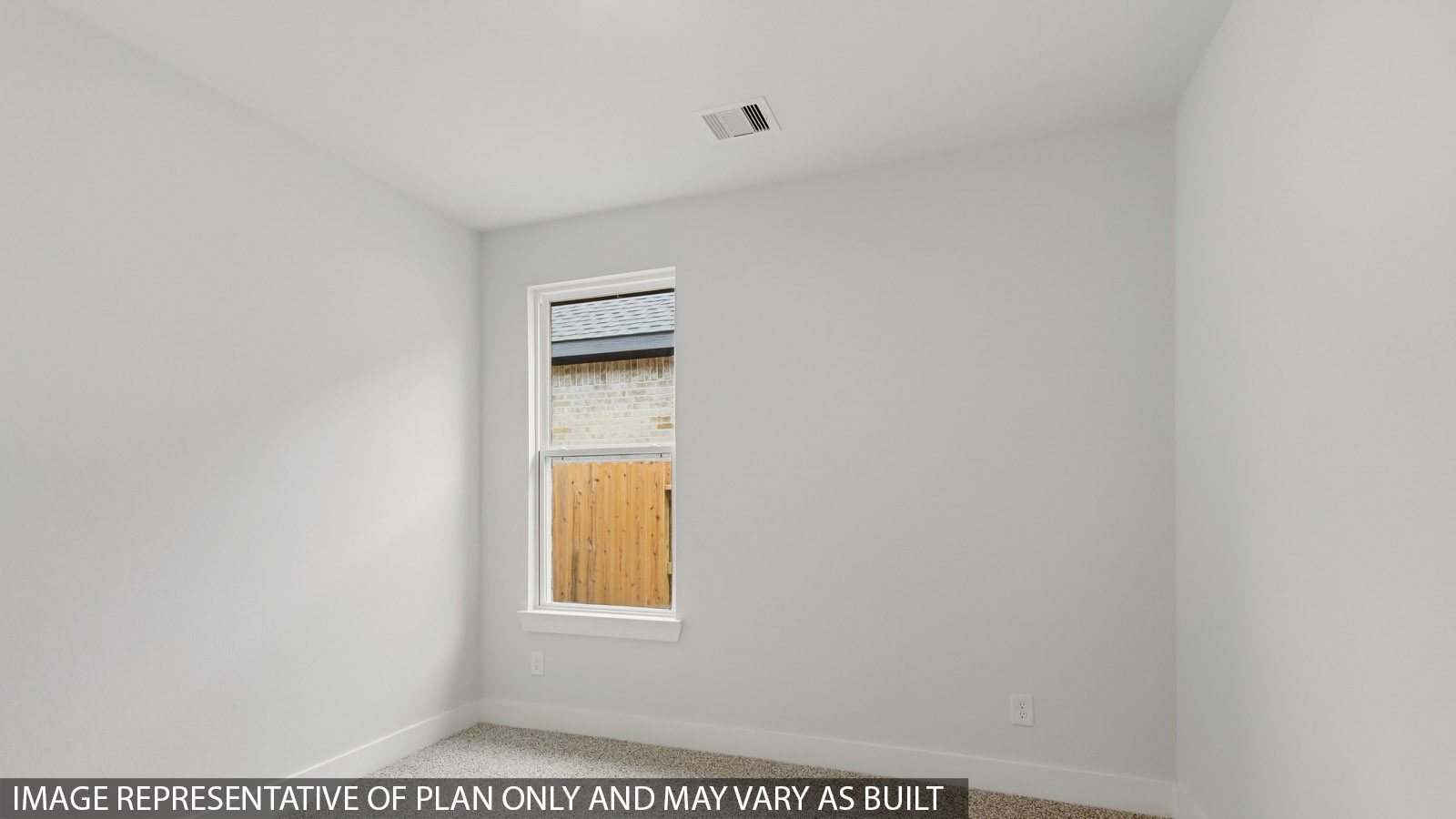 Secondary bedroom with carpet flooring