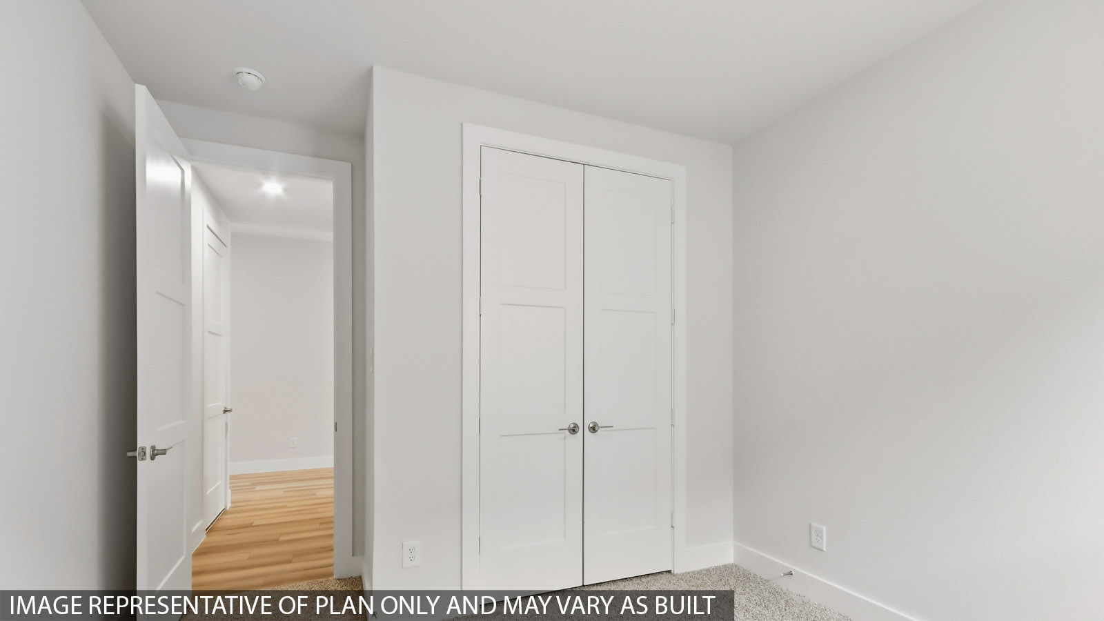 Secondary bedroom with carpet flooring