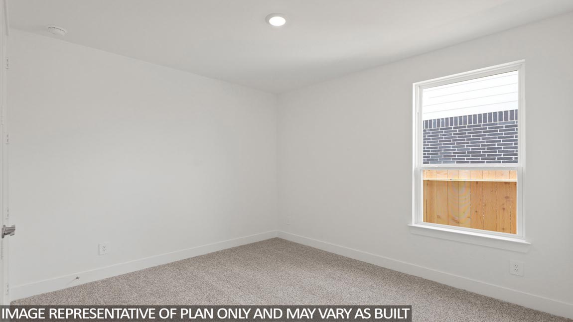 Secondary bedroom with carpet flooring
