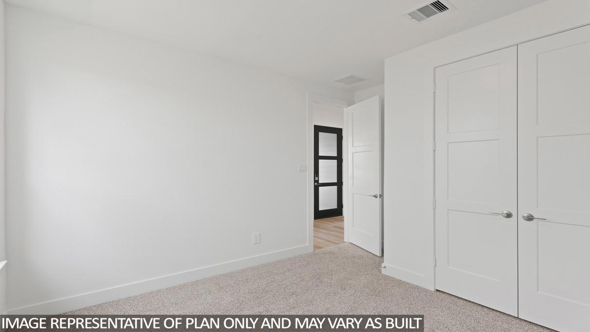 Secondary bedroom with carpet flooring