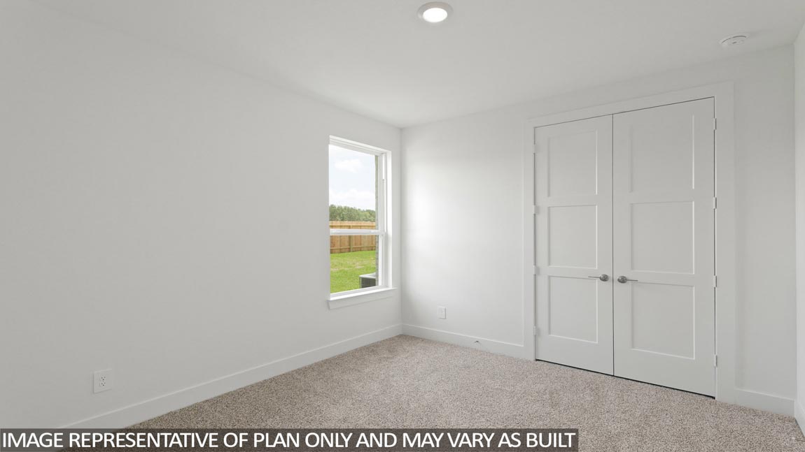 Secondary bedroom with carpet flooring