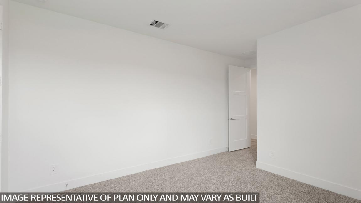 Secondary bedroom with carpet flooring