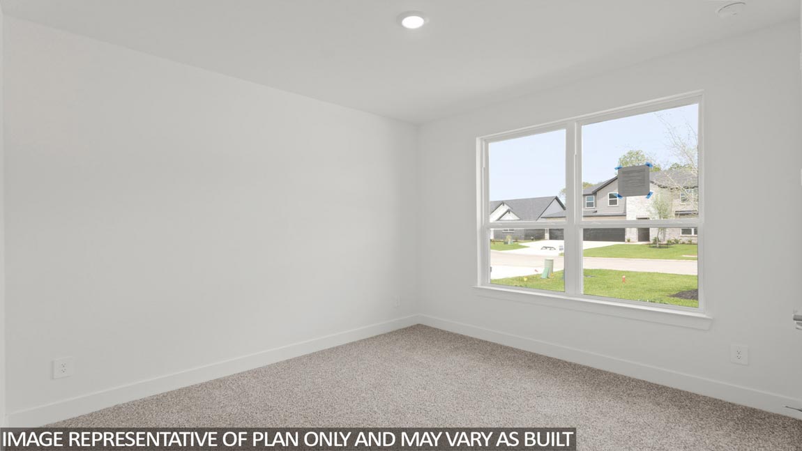 Secondary bedroom with carpet flooring