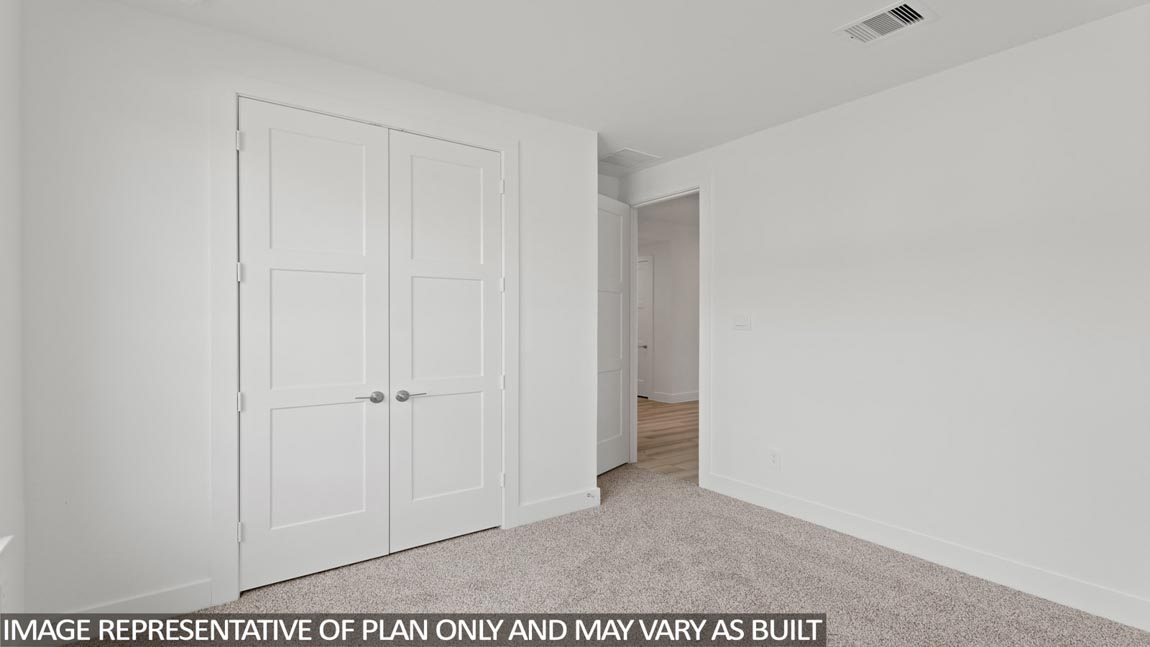 Secondary bedroom with carpet flooring