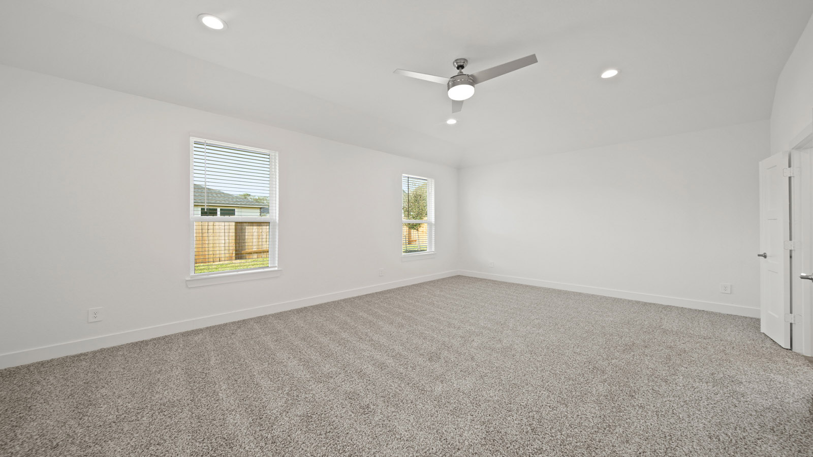 Primary bedroom with carpet flooring