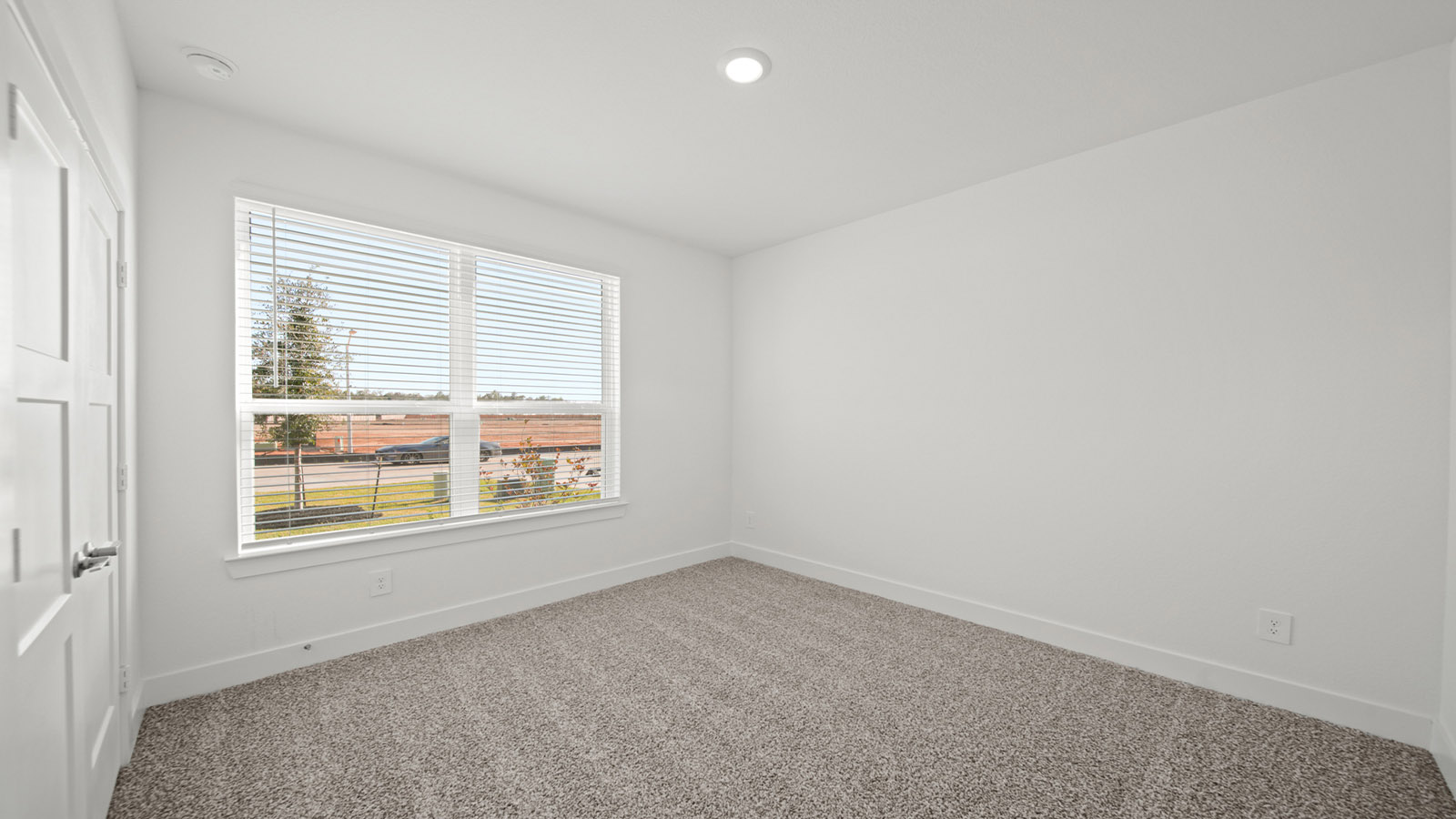 Secondary bedroom with carpet flooring