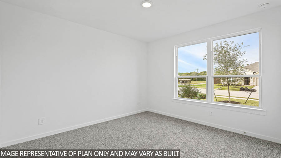Secondary bedroom with carpet flooring
