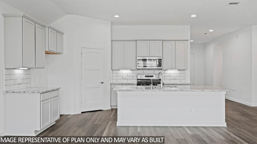 Kitchen with an island and stainless-steel appliances.