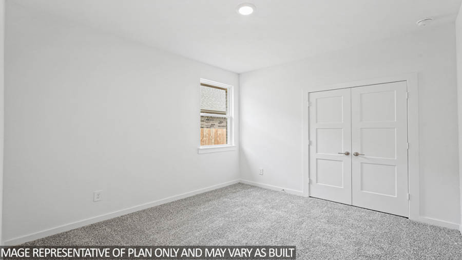 Secondary bedroom with carpet flooring