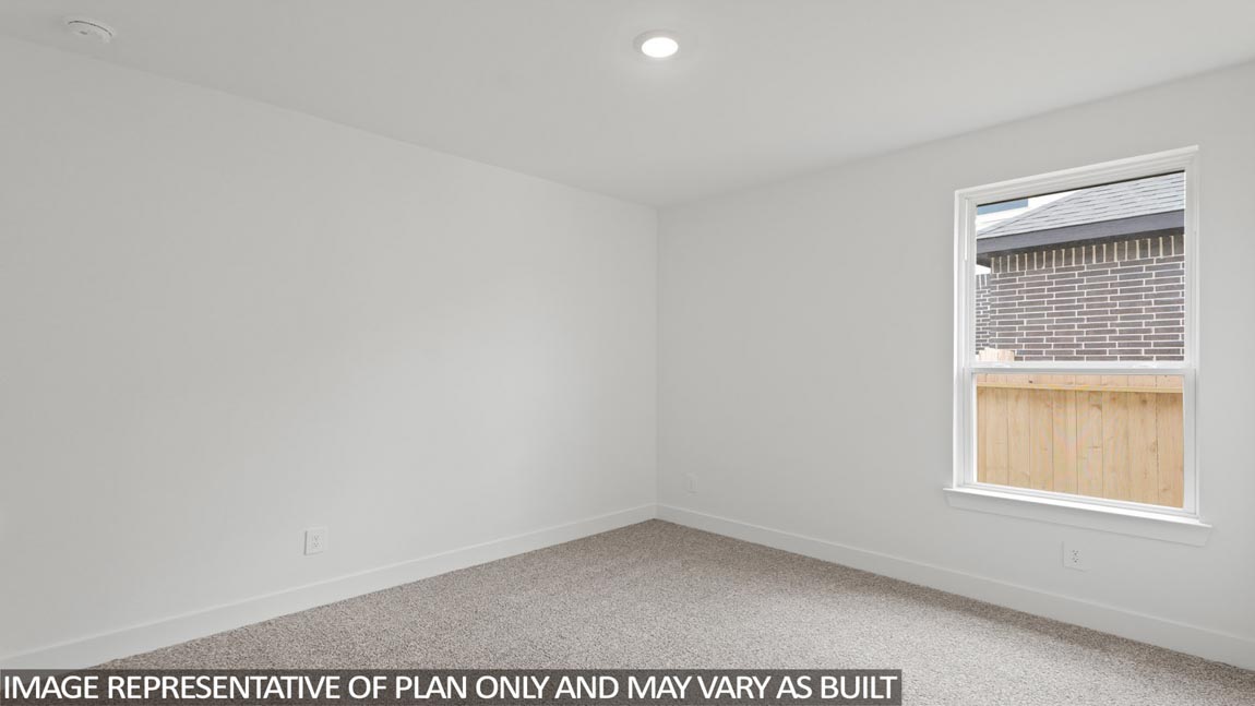 Secondary bedroom with carpet flooring