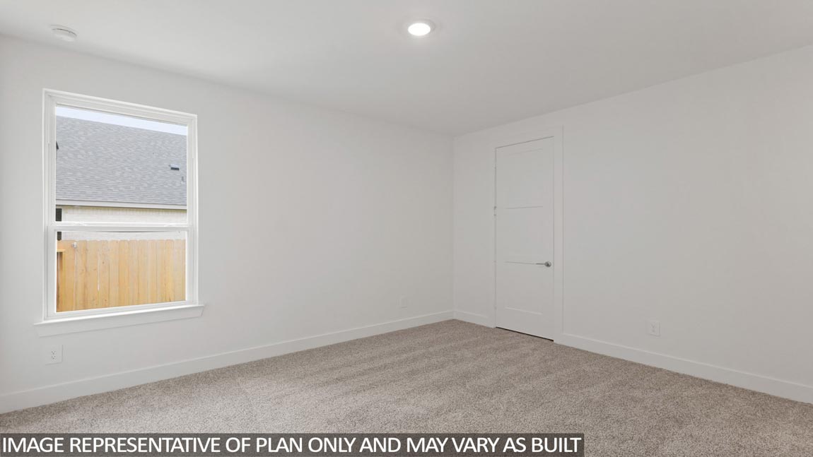 Secondary bedroom with carpet flooring