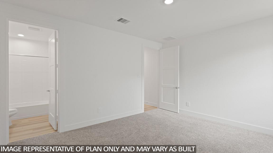 Secondary bedroom with carpet flooring