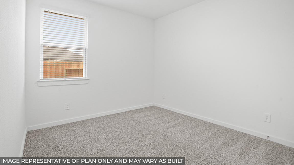 Secondary bedroom with carpet flooring and a bright window.