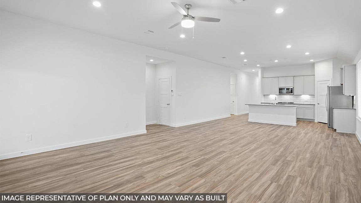 Open concept living and dining area with vinyl flooring and bright windows.