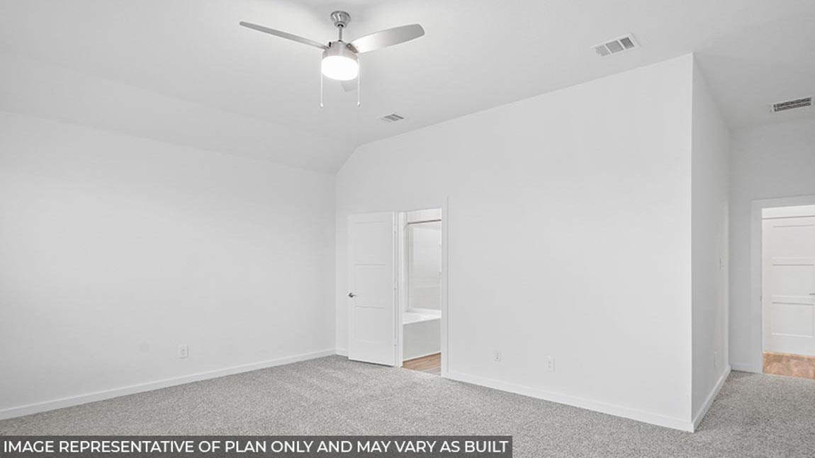 Primary bedroom with carpet flooring, a ceiling fan, and bright windows.