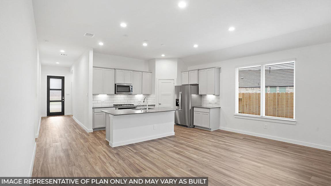 Open concept living and dining area with vinyl flooring and bright windows.