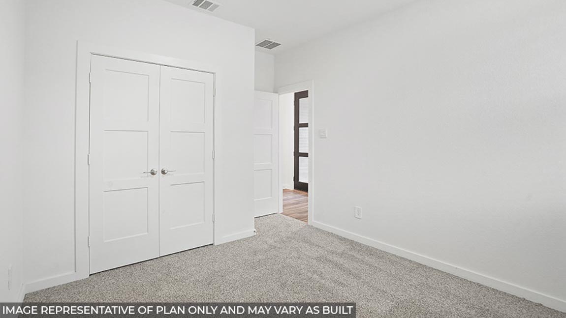 Secondary bedroom with a tall closet.