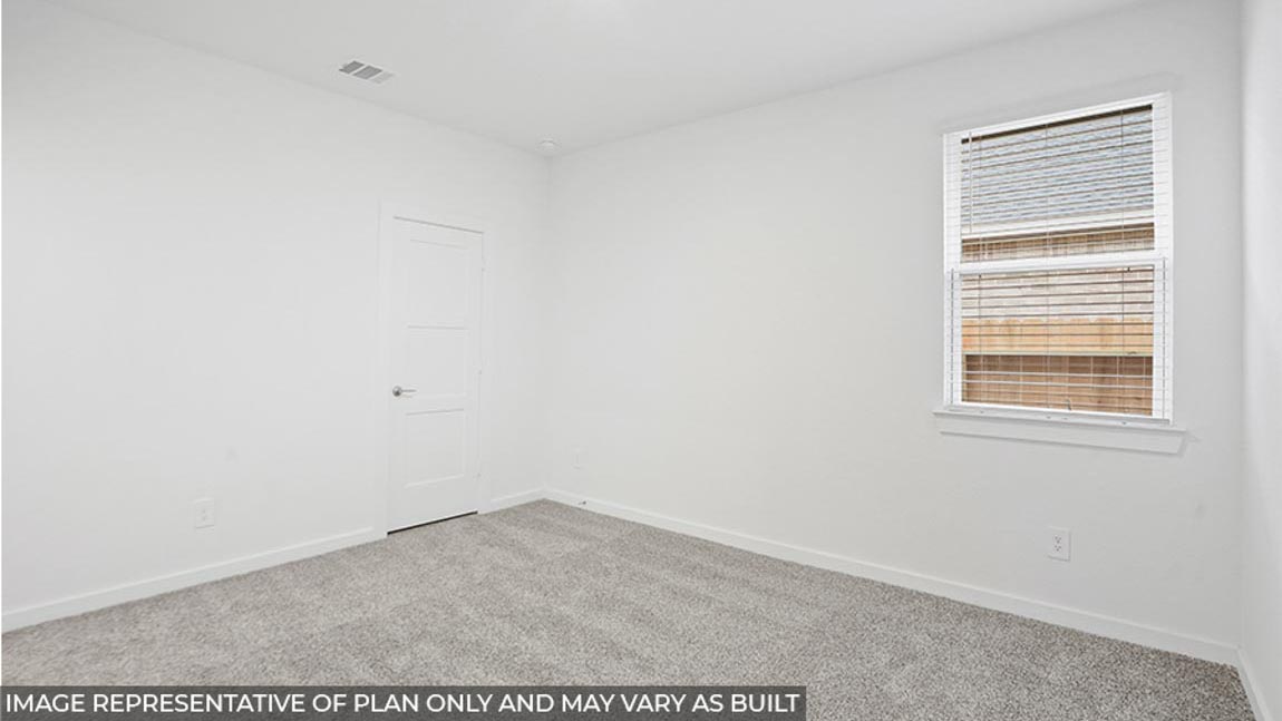Secondary bedroom with carpet flooring and a bright window.