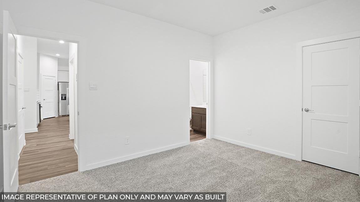 Secondary bedroom with a tall closet.