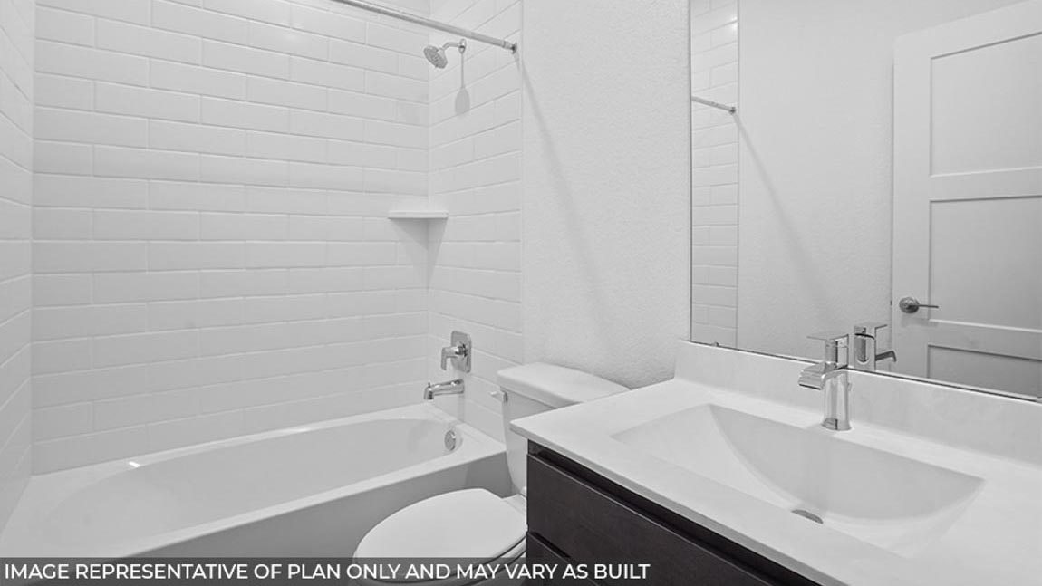 Secondary bathroom with a tile tub/shower combo.