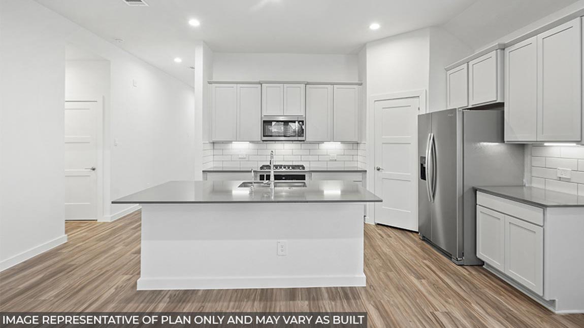 Kitchen with and island and stainless-steel appliances.
