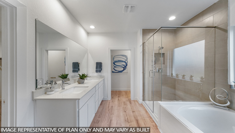 Staged primary bathroom with vinyl flooring, a double sink, a standing shower, a tile tub, and a frosted window.