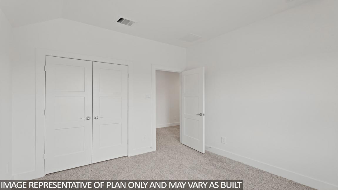 Secondary bedroom with carpet flooring