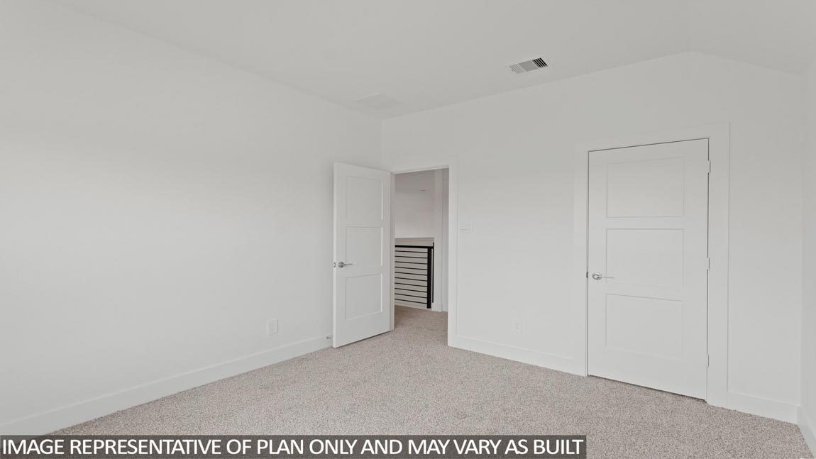 Secondary bedroom with carpet flooring