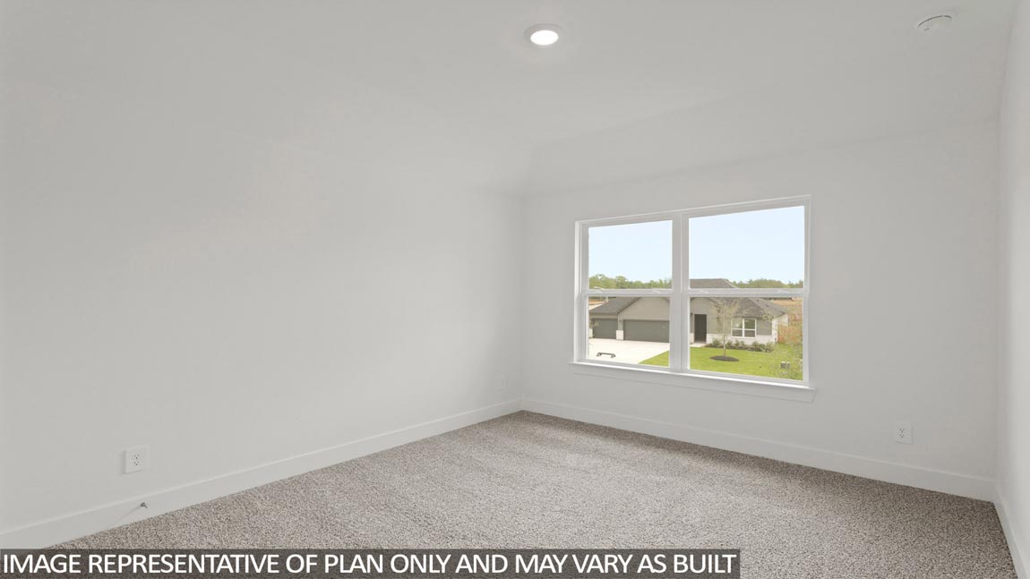 Secondary bedroom with carpet flooring