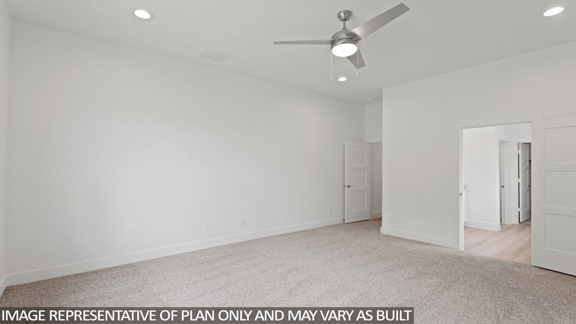 Primary bedroom with carpet flooring