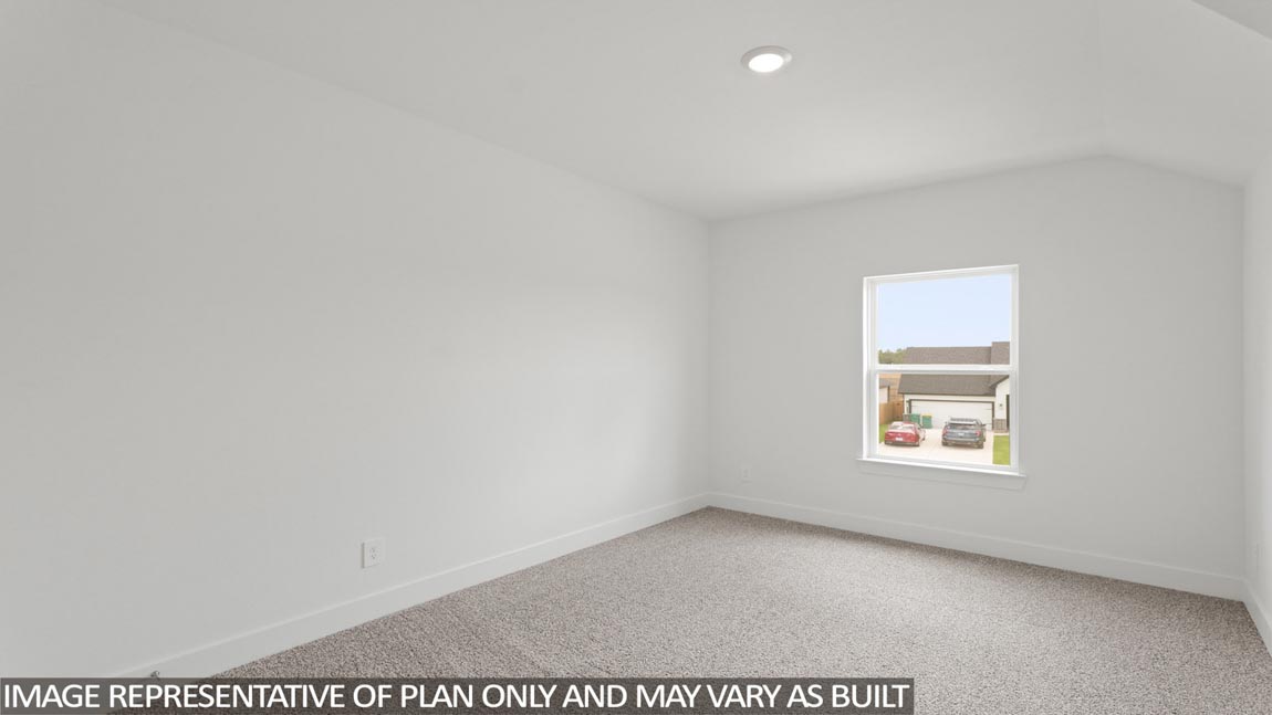 Secondary bedroom with carpet flooring