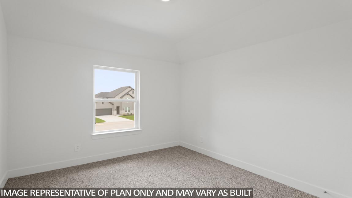 Secondary bedroom with carpet flooring