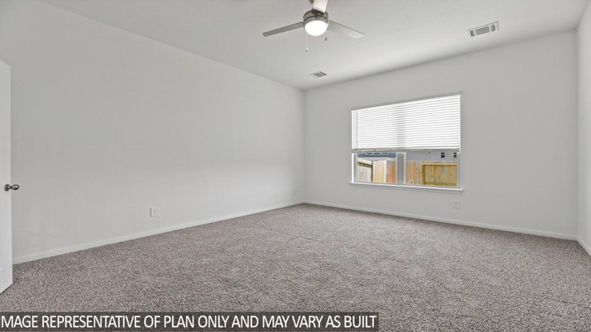 Primary bedroom with carpet flooring, a ceiling fan, and bright windows.