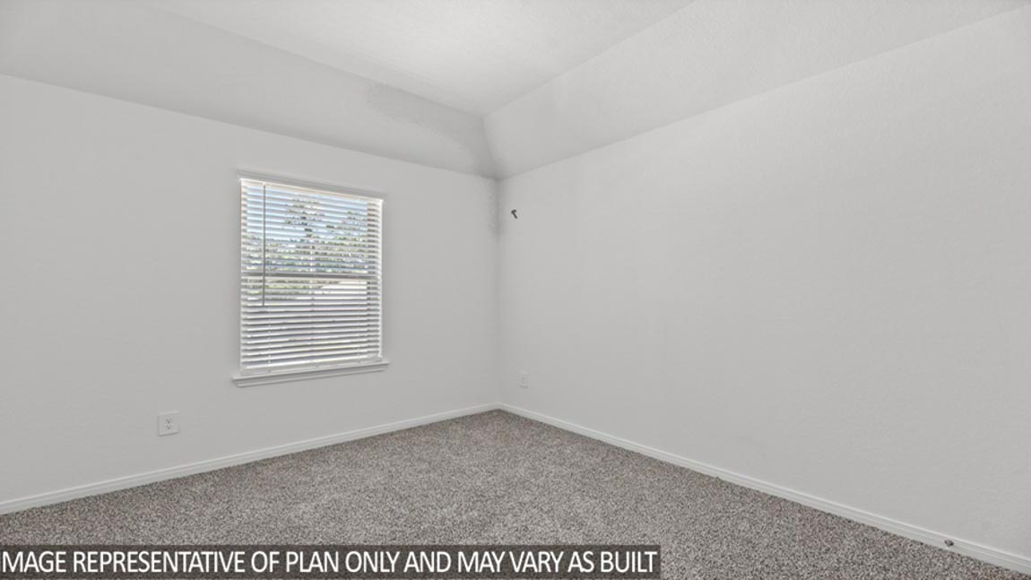 Secondary bedroom with carpet flooring and a bright window.