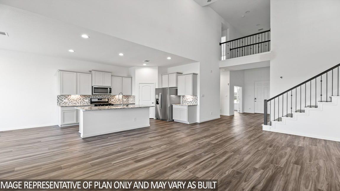 Open concept living and dining area with vinyl flooring and bright windows.