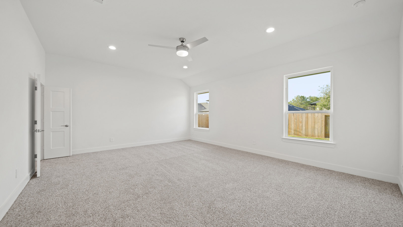 Primary bedroom with carpet flooring