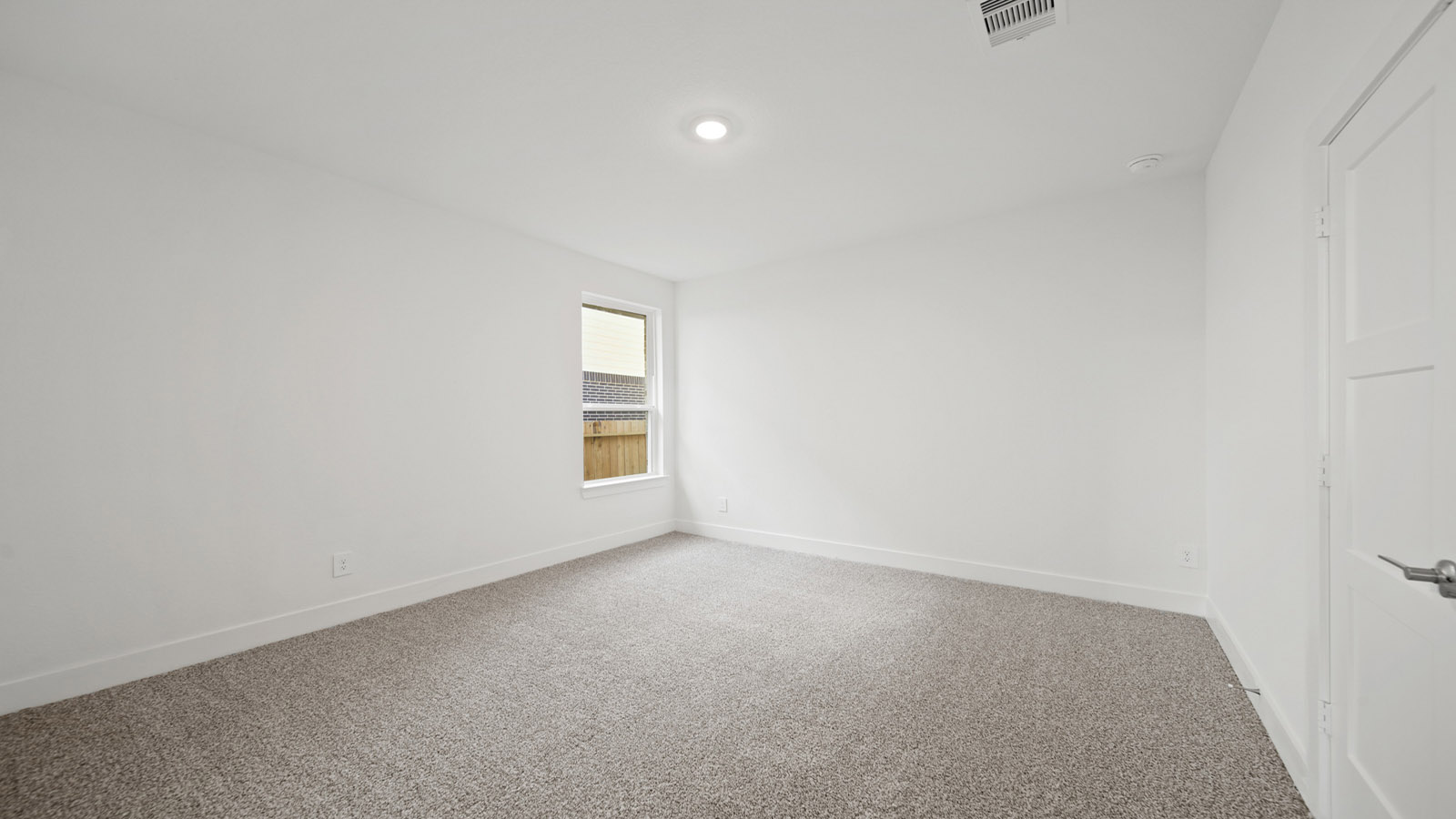 Secondary bedroom with carpet flooring