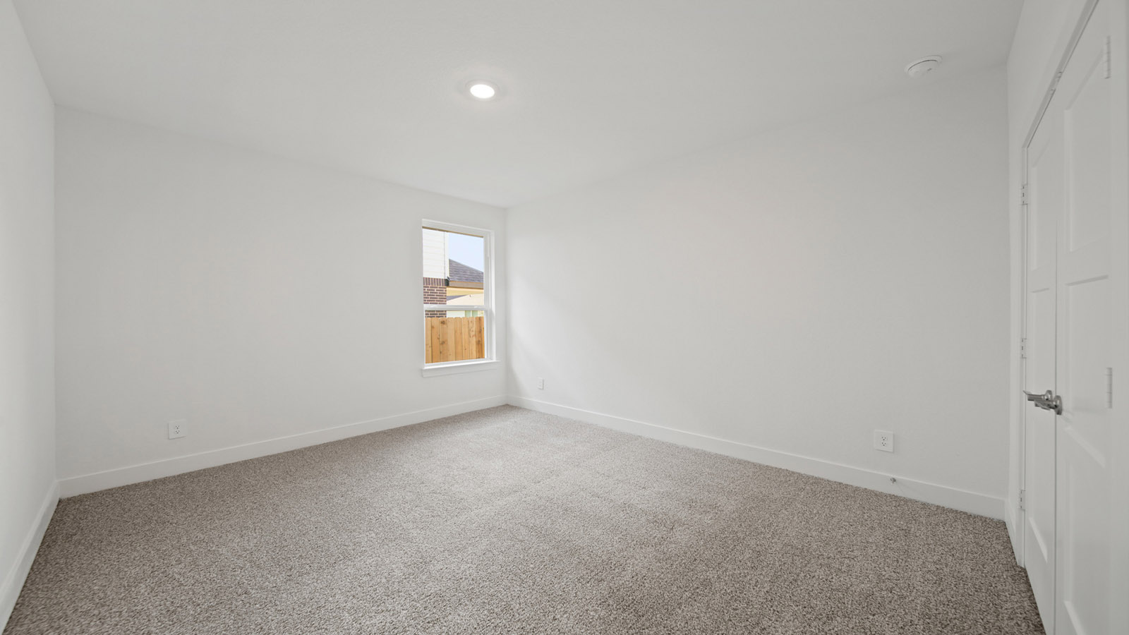 Secondary bedroom with carpet flooring