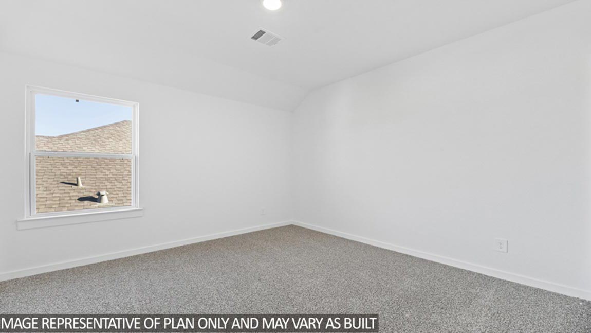 Secondary bedroom with carpet flooring