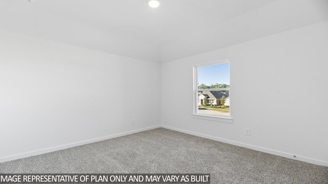 Secondary bedroom with carpet flooring and a bright window.