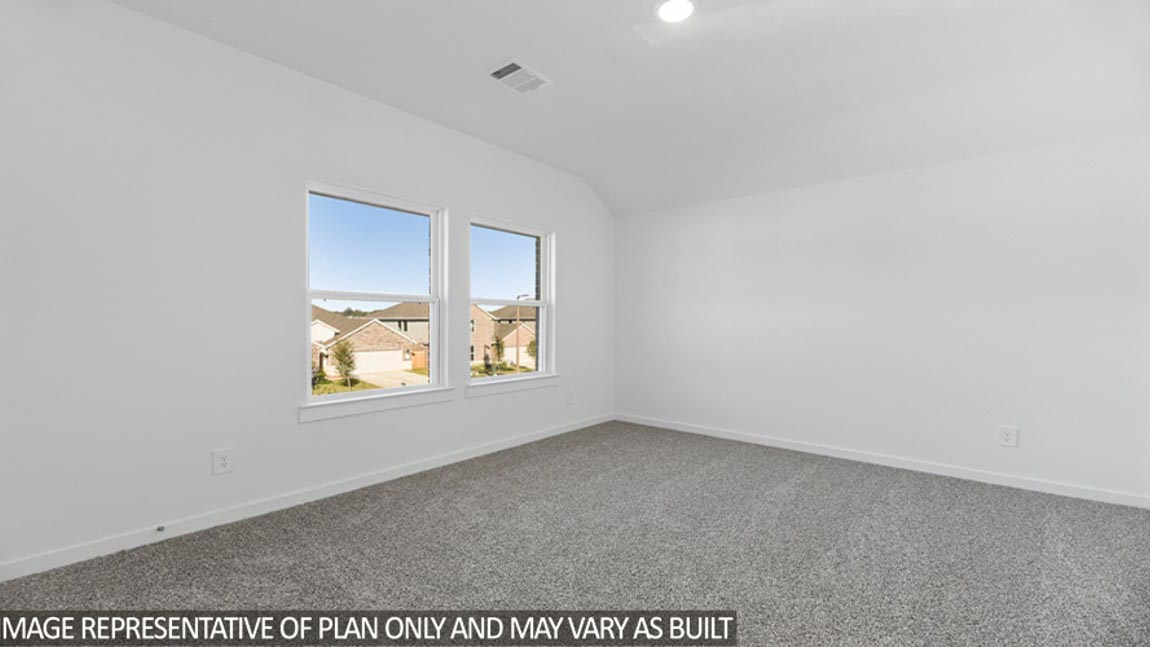 Secondary bedroom with carpet flooring and a bright window.