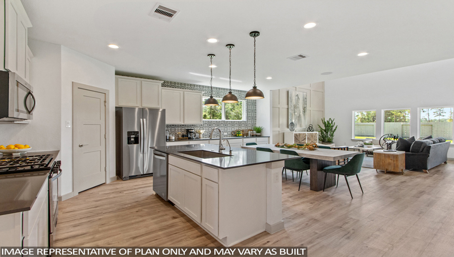 Staged kitchen with stainless-steel appliances and an island.