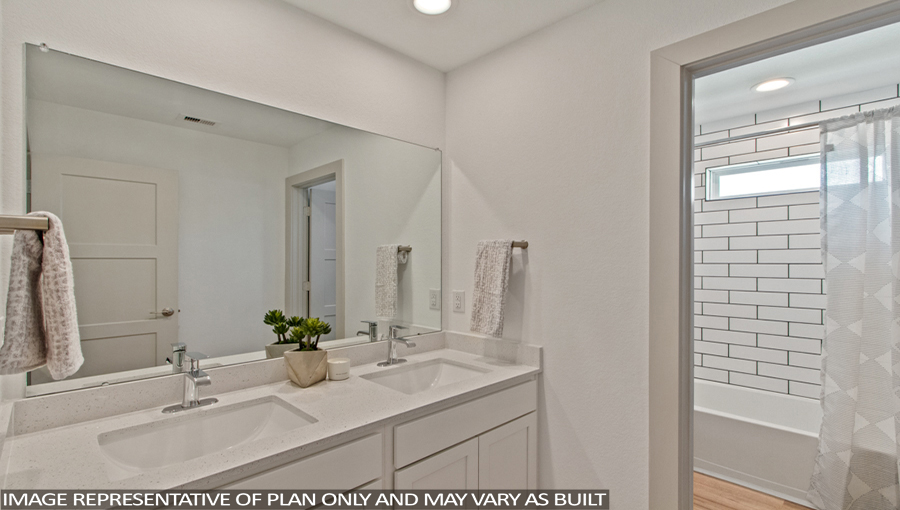 Staged secondary bathroom with vinyl flooring and a double sink.