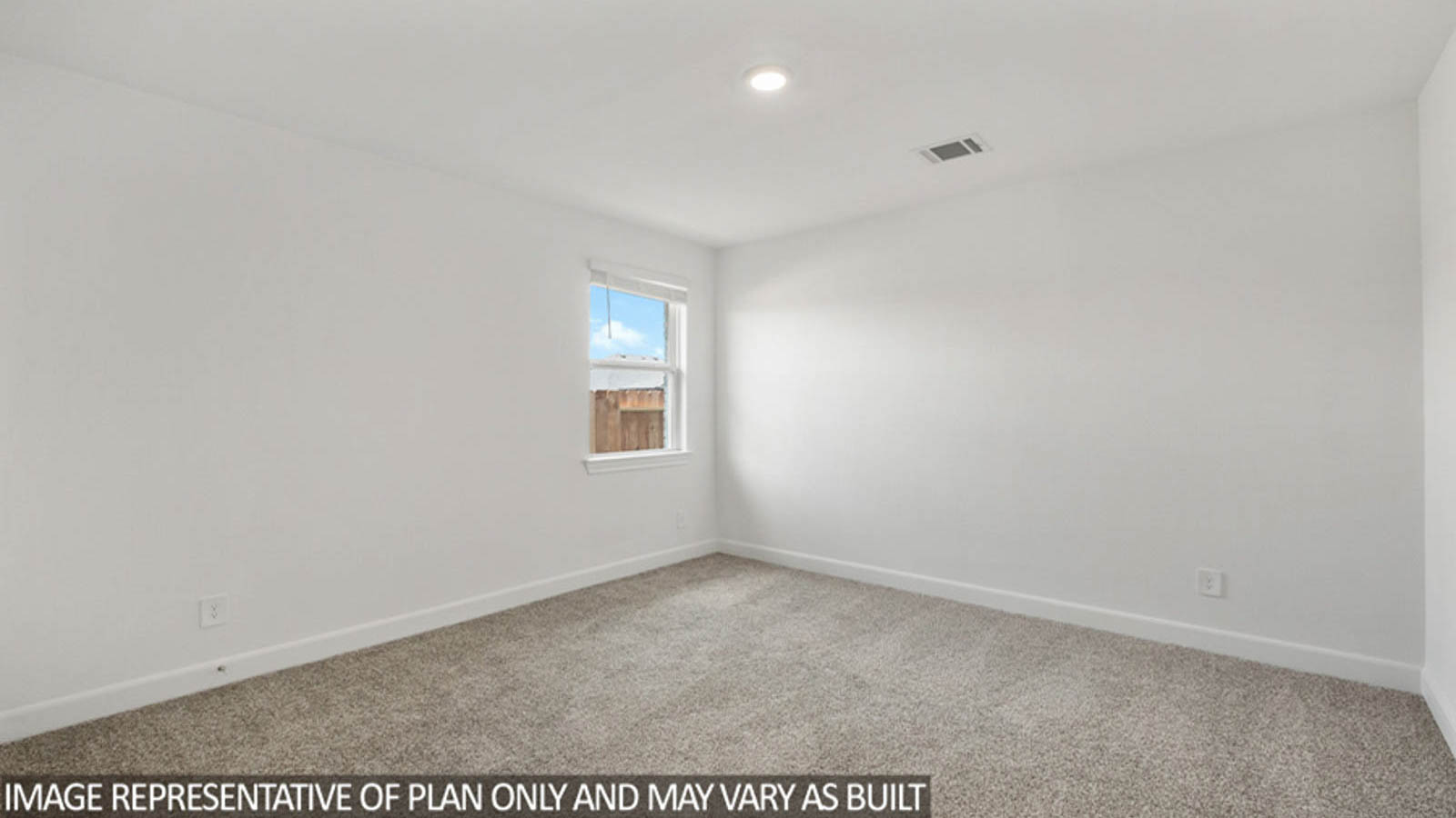 Secondary bedroom with carpet flooring